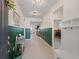 Bright foyer featuring wood paneling, tile flooring, and a view of the home's interior at 7206 Sw 60Th Ln, Ocala, FL 34474