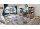 This bright living room boasts recessed lights, tile floors, and sliding glass doors to the covered patio at 7206 Sw 60Th Ln, Ocala, FL 34474