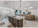 Open-concept kitchen and living room with a granite island and plenty of natural light at 7206 Sw 60Th Ln, Ocala, FL 34474