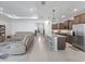 Open-concept layout with a kitchen featuring an island and a comfortable living area at 7206 Sw 60Th Ln, Ocala, FL 34474