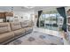 Spacious living room includes a comfortable sofa, tile floors, recessed lighting, and access to the patio at 7206 Sw 60Th Ln, Ocala, FL 34474