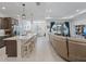 Bright, open-concept living room with a modern kitchen and large sliding glass doors at 7206 Sw 60Th Ln, Ocala, FL 34474