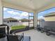 Relaxing screened patio with comfortable seating and a view of the backyard, perfect for outdoor entertaining and enjoyment at 7206 Sw 60Th Ln, Ocala, FL 34474