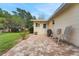 Charming brick patio with grill, seating, and lush green lawn offers a relaxing outdoor space at 8785 Sw 93Rd Ln # C, Ocala, FL 34481