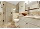 Bright bathroom features tile shower with glass enclosure and granite topped vanity at 8785 Sw 93Rd Ln # C, Ocala, FL 34481