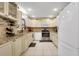 Classic kitchen with white cabinets, stainless steel appliances, and granite countertops at 8785 Sw 93Rd Ln # C, Ocala, FL 34481