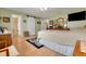Bright main bedroom featuring hardwood floors, ensuite access, and sliding barn door at 8785 Sw 93Rd Ln # C, Ocala, FL 34481