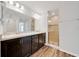 Modern bathroom showcasing double sinks, dark cabinets, and a glass-enclosed shower at 8943 Se 41St Court Rd, Ocala, FL 34480