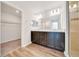 Elegant bathroom boasts double sinks, dark wood cabinets, and a glass-enclosed shower at 8943 Se 41St Court Rd, Ocala, FL 34480