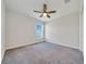 Well-lit bedroom featuring a modern ceiling fan and a window for natural light at 8943 Se 41St Court Rd, Ocala, FL 34480