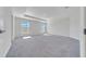 Spacious bedroom features a tray ceiling, carpet, and natural light from two windows at 8943 Se 41St Court Rd, Ocala, FL 34480