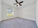 Bright bedroom with a ceiling fan and large window, offering ample natural light at 8943 Se 41St Court Rd, Ocala, FL 34480