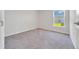 Bright bedroom featuring a window and plush carpeting creating a comfortable living space at 8943 Se 41St Court Rd, Ocala, FL 34480