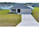 Beautiful home with a well-manicured lawn and a spacious two-car garage at 8943 Se 41St Court Rd, Ocala, FL 34480