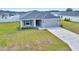 Well-maintained home featuring a lush front lawn and an attached two-car garage at 8943 Se 41St Court Rd, Ocala, FL 34480