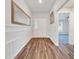 Bright foyer with wood flooring, decorative molding, and a view into the living area at 8943 Se 41St Court Rd, Ocala, FL 34480