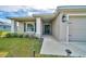 Inviting front porch with decorative lights, stylish columns, and a well-manicured lawn at 8943 Se 41St Court Rd, Ocala, FL 34480