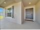 Cozy front porch with a grey door, decorative shutters, and a welcoming entrance at 8943 Se 41St Court Rd, Ocala, FL 34480