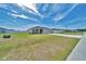 Well-maintained single-story home with a green lawn and a concrete driveway at 8943 Se 41St Court Rd, Ocala, FL 34480