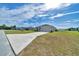 Inviting single-story home with a spacious driveway and a lush green lawn at 8943 Se 41St Court Rd, Ocala, FL 34480