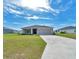 Single-story home featuring a well-maintained lawn and a convenient two-car garage at 8943 Se 41St Court Rd, Ocala, FL 34480