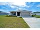 Charming single-story home with a well-manicured lawn and attached two-car garage at 8943 Se 41St Court Rd, Ocala, FL 34480