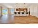 Open kitchen with island seating, pendant lighting, dark cabinetry, and stainless appliances at 8943 Se 41St Court Rd, Ocala, FL 34480