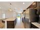 Open kitchen features stainless appliances, granite countertops, and backyard view at 8943 Se 41St Court Rd, Ocala, FL 34480