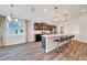Kitchen with dark cabinets, an island with seating, and contemporary pendant lighting at 8943 Se 41St Court Rd, Ocala, FL 34480