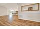 Open-concept living area with wood floors, leading to a kitchen with a breakfast bar at 8943 Se 41St Court Rd, Ocala, FL 34480