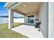 Covered patio area with room for dining and grilling, perfect for outdoor entertaining at 8943 Se 41St Court Rd, Ocala, FL 34480