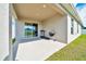 Covered patio with grill and sliding door access to the backyard at 8943 Se 41St Court Rd, Ocala, FL 34480