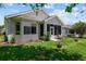 Charming backyard with lush green lawn and a cozy sunroom, perfect for relaxation and outdoor enjoyment at 9408 Se 132Nd Loop, Summerfield, FL 34491
