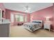 Comfortable bedroom with bay window, neutral carpet, and ceiling fan at 9408 Se 132Nd Loop, Summerfield, FL 34491