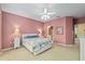 Bedroom with neutral carpet, ceiling fan, and a view to the ensuite bathroom at 9408 Se 132Nd Loop, Summerfield, FL 34491