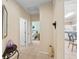 Inviting hallway featuring neutral tile flooring and access to a bedroom, offering a glimpse into the home's layout at 9408 Se 132Nd Loop, Summerfield, FL 34491