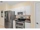 Kitchen area featuring stainless steel appliances, a double oven, and ample storage space at 9408 Se 132Nd Loop, Summerfield, FL 34491
