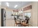 Eat-in kitchen featuring tile floors, stainless steel refrigerator, eat-in table, and great natural light at 9408 Se 132Nd Loop, Summerfield, FL 34491