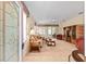 Bright living room with neutral carpet, ceiling fan, and sliding doors to lanai at 9408 Se 132Nd Loop, Summerfield, FL 34491
