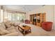 Spacious living room with neutral carpet, ceiling fan, and comfortable furnishings at 9408 Se 132Nd Loop, Summerfield, FL 34491
