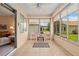 Inviting sunroom with ceiling fan, tile flooring, and great backyard views at 9408 Se 132Nd Loop, Summerfield, FL 34491