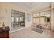 Relaxing sunroom with tile flooring, ceiling fan, and sliding glass doors for easy indoor-outdoor living at 9408 Se 132Nd Loop, Summerfield, FL 34491