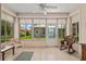 Bright sunroom with tile flooring, large windows, and comfortable seating at 9408 Se 132Nd Loop, Summerfield, FL 34491
