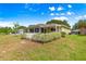 Well-maintained backyard with a white picket fence surrounding the covered patio area at 9750 Sw 97Th Pl, Ocala, FL 34481
