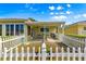 Charming backyard featuring a white picket fence enclosing a patio and landscaped garden at 9750 Sw 97Th Pl, Ocala, FL 34481
