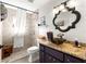 Bathroom with walk-in shower, granite counter, unique bowl sink, and a decorative mirror at 9750 Sw 97Th Pl, Ocala, FL 34481