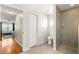 Bathroom showcases a modern glass shower stall and a commode with wood-look tile flooring at 9750 Sw 97Th Pl, Ocala, FL 34481