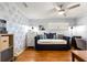 Cozy bedroom featuring wood floors, ceiling fan and comfortable daybed at 9750 Sw 97Th Pl, Ocala, FL 34481