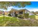 Well-manicured single-story home featuring a landscaped yard with mature trees at 9750 Sw 97Th Pl, Ocala, FL 34481