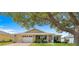 Charming single-story home featuring a well-maintained lawn and inviting front porch at 9750 Sw 97Th Pl, Ocala, FL 34481